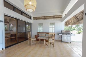 a kitchen with a table and chairs in a room at Surf Salvacion in San Felipe de Puerto Plata