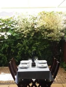 a table with a white table cloth and two chairs at GRECOS HOLIDAY in Hel