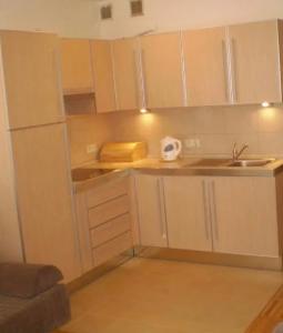 a small kitchen with white cabinets and a sink at GRECOS HOLIDAY in Hel