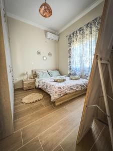 a bedroom with a bed and a window at Alyki Salamina House in Salamina