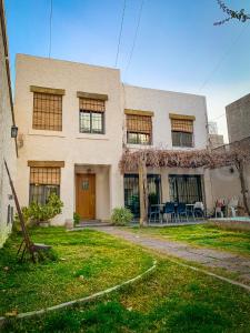 een groot huis met een tuin ervoor bij Casa Avellaneda in Mendoza