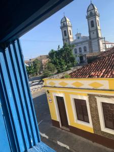 a view from a window of a building with two towers at Pousada Solar Colonial in Iguape