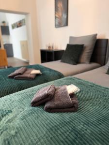 two beds with towels sitting on top of them at Wohnung im Zentrum 2 in Magdeburg