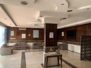 a lobby with couches and a tv in a building at مراسم رفحاء للشقق المخدومة in Rafha