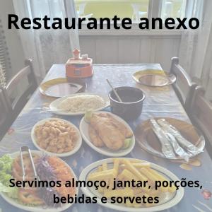 a table topped with plates of food on a table at Pousada Oceano Azul in Ilha do Mel