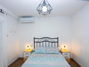 a bedroom with a bed and two night stands at Playa el Clot - Vinaròs in Vinaròs