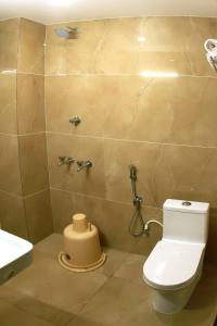 a bathroom with a toilet and a sink at Hotel Sri Devi in Kanyakumari