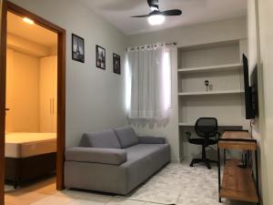 a living room with a couch and a bed and a window at Studio 304 ao lado do Shopping e Metrô in Brasilia +15 photos