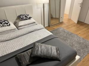 two beds with pillows on them in a bedroom at Spacious Apartment near Train Station in Ljubljana