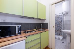 a kitchen with a microwave and a sink at Charming suite with view in the heart of Rome in Rome