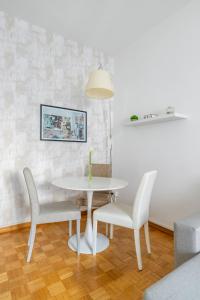 a white table and chairs in a room at Charming suite with view in the heart of Rome in Rome