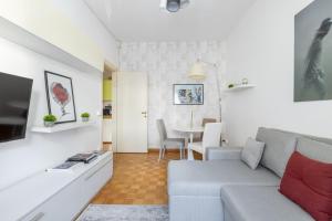 a living room with a couch and a table at Charming suite with view in the heart of Rome in Rome