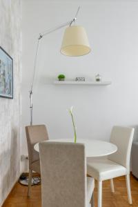 a white dining room with a white table and chairs at Charming suite with view in the heart of Rome in Rome