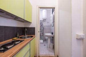 a small kitchen with a sink and a toilet at Charming suite with view in the heart of Rome in Rome