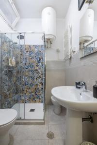 a bathroom with a shower and a toilet and a sink at Charming suite with view in the heart of Rome in Rome