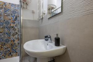a bathroom with a white sink and a mirror at Charming suite with view in the heart of Rome in Rome