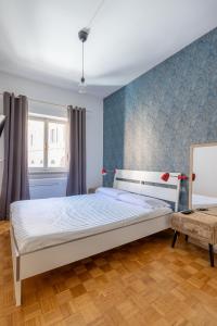 a bedroom with a bed and a blue wall at Charming suite with view in the heart of Rome in Rome
