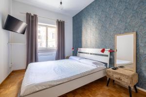 a bedroom with a bed and a blue wall at Charming suite with view in the heart of Rome in Rome