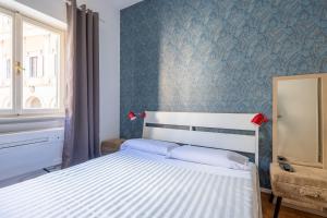 a bedroom with a white bed and a window at Charming suite with view in the heart of Rome in Rome