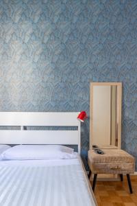 a bedroom with a bed and a mirror and a chair at Charming suite with view in the heart of Rome in Rome