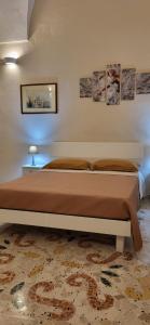 Tempat tidur dalam kamar di Casa vacanze "ALIZZA"