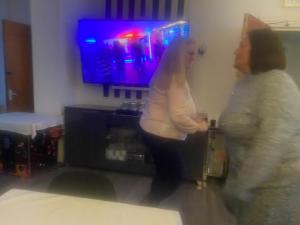 two women standing in a living room playing a video game at The Cosy Nook in Blackpool