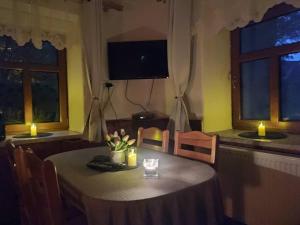 uma sala de jantar com uma mesa com velas em Naše chalupa em Stará Červená Voda