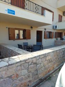 a stone retaining wall in front of a building at Μοντέρνο Σπίτι in Monemvasia
