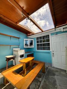 a kitchen with a wooden table and a window at Azure Escape in Soufrière