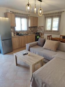 a living room with two couches and a table at Μοντέρνο Σπίτι in Monemvasia