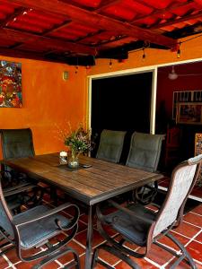 a wooden table and chairs in a room at Departamentos “Ama” in Puerto Vallarta