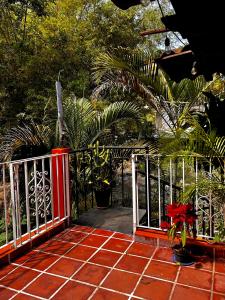 a porch with a gate and flowers on it at Departamentos “Ama” in Puerto Vallarta