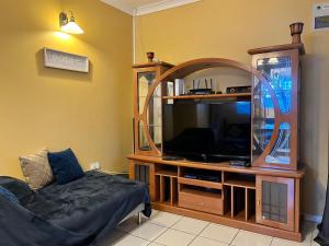 a living room with a tv and a mirror at Azure Escape in Soufrière