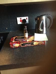 a tea kettle sitting on top of a counter at Cameron apartment Loch Ness in Fort Augustus