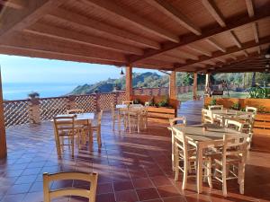 un restaurante con mesas y sillas en un patio en Valle Lumia en Letoianni