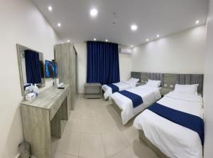 a hotel room with two beds and a television at Petra Heaven Boutique in Wadi Musa