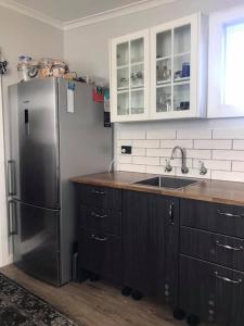 a kitchen with a stainless steel refrigerator and a sink at Bellamona in Longford