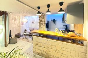 a kitchen with a counter top and a living room at Cocon chaleureux entièrement renové à 150m de le Seine in Saint-Mammès
