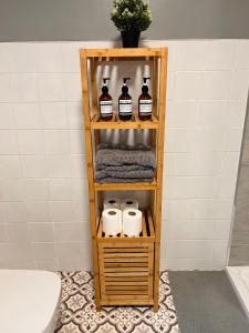 a shelf in a bathroom with toiletries on it at Kings Bridge Townhouse in Belfast