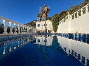 a pool of water in front of a building at Casa Moya Moraira - Seaview Villa in Teulada