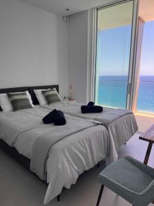 a bedroom with a large bed with a large window at Ayia Napa Marina Exclusive Apartment in Ayia Napa