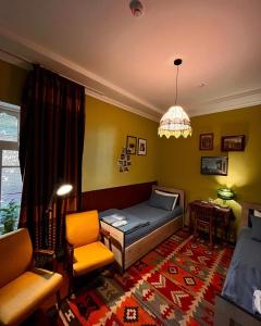 a living room with a bed and a chair at Old Radio hostel in Samarkand