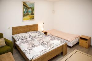 a small room with two beds and a couch at Biró apartmanház Sármellék in Sármellék