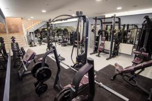 a gym with a bunch of tread machines in it at Apartmani Villa Grande in Bugojno