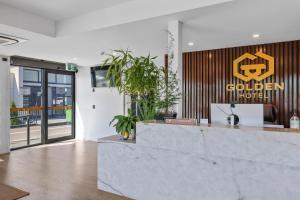 a lobby of a building with a reception counter at Golden Hotel in Christchurch