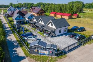 an aerial view of a house with a parking lot at Domki letniskowe Agata in Jantar