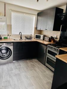 a kitchen with a sink and a dishwasher at *Newcastle City* Modern Flat With FREE Parking in Newcastle upon Tyne