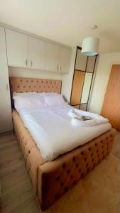 a bedroom with a large bed with white sheets at *Newcastle City* Modern Flat With FREE Parking in Newcastle upon Tyne