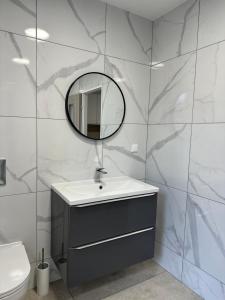 a bathroom with a sink and a mirror at Guben Wohnungen in Guben