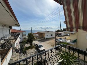 an apartment balcony with a view of the ocean at VILLA KALIBA SUMMER HOUSE in Kalivia Poligirou